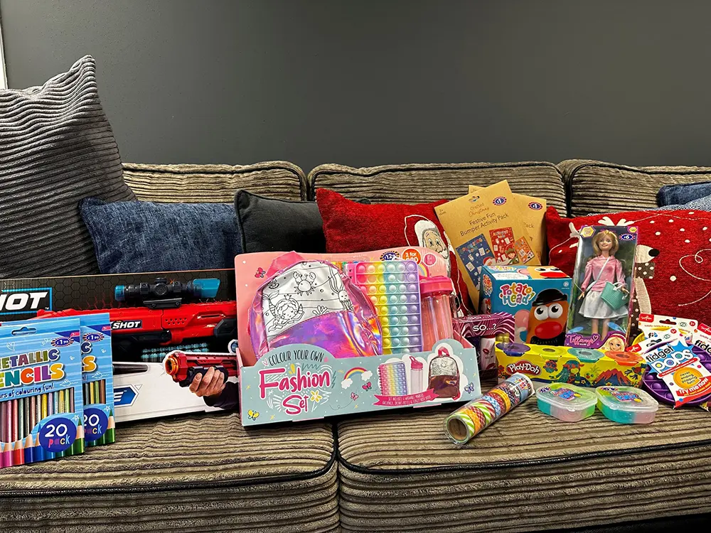 Toy donations on brown sofa